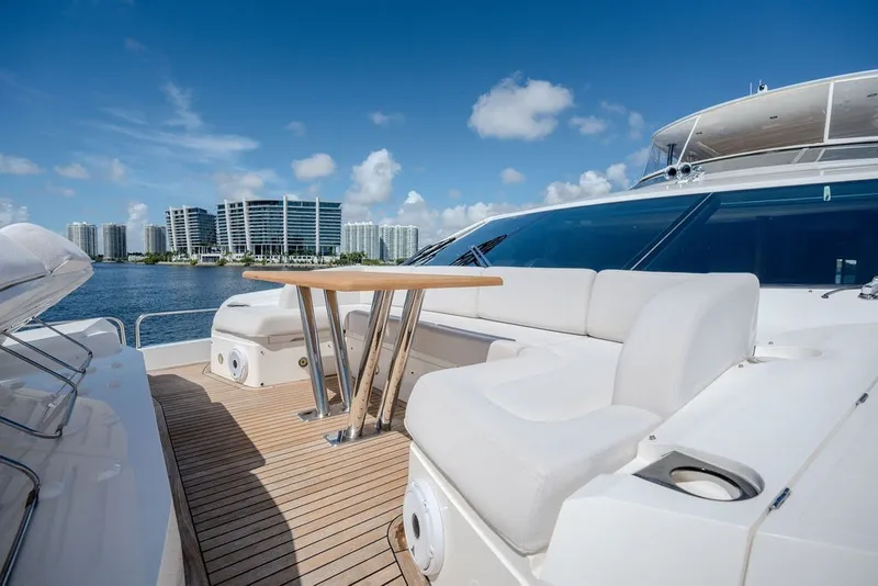 Slide: The Image of Luxurious 2019 Sunseeker 86 Yacht deck with seating, overlooking waterfront cityscape. - 29