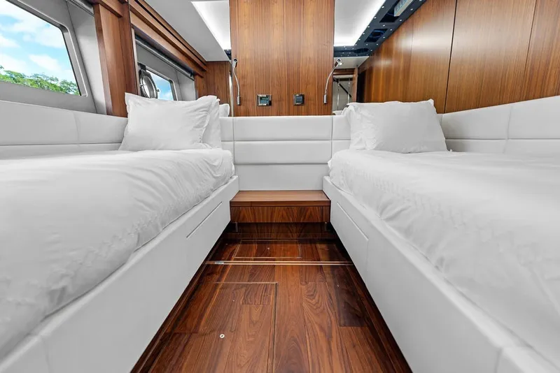 Slide: The Image of Luxurious twin cabin interior on a 2019 Sunseeker 86 Yacht with elegant wood finishes. - 91