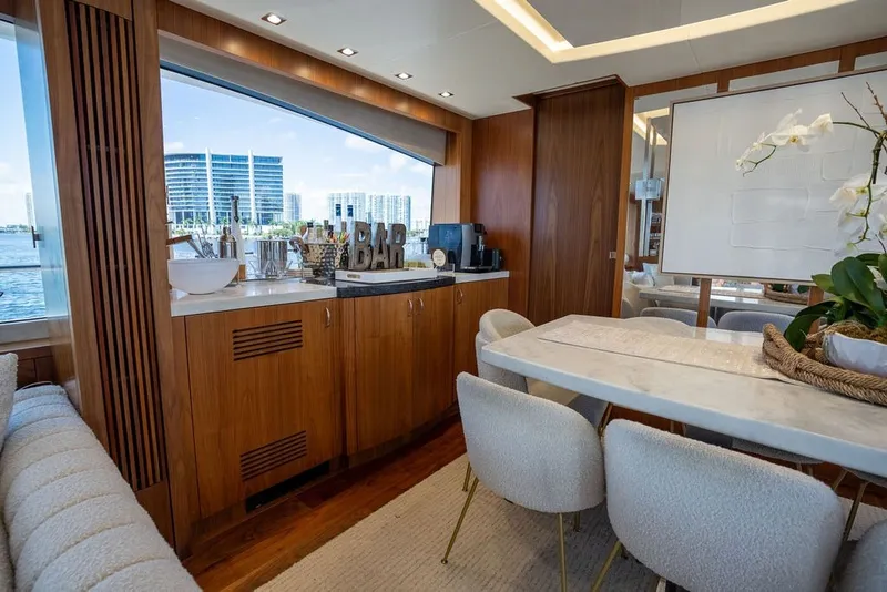 Slide: The Image of Luxurious interior of 2019 Sunseeker 86 Yacht with elegant dining area and bar setup. - 69