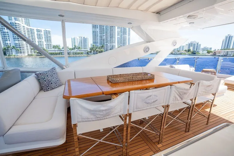 Slide: The Image of Luxurious Sunseeker 86 Yacht 2019 with elegant outdoor dining area and waterfront city view. - 44