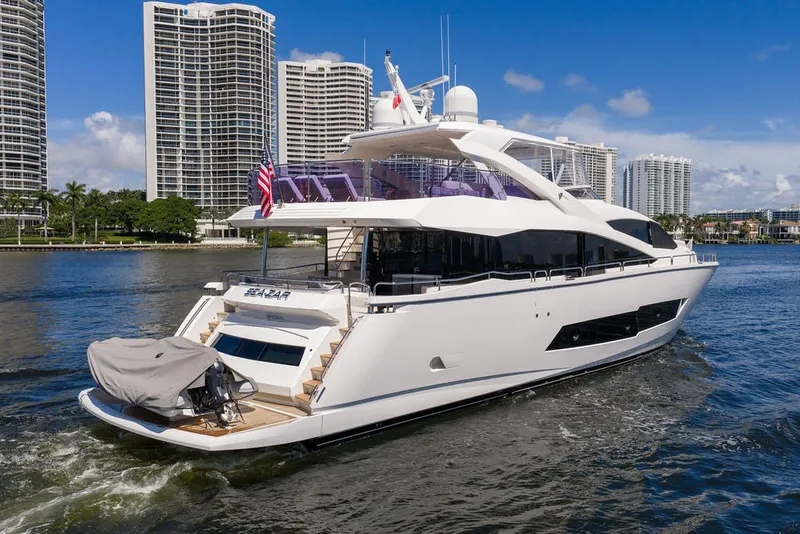Slide: The Image of Luxurious 2019 Sunseeker 86 Yacht cruising near modern waterfront skyscrapers. - 22