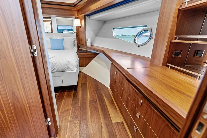 Slide: The Image of Luxurious 2019 Sunseeker 86 Yacht bedroom with elegant wood finishes and ocean view. - 98