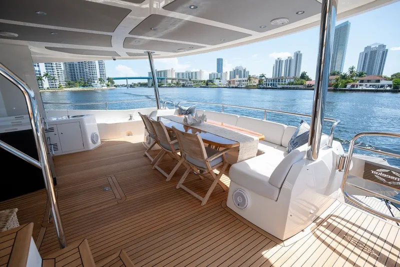 Slide: The Image of Luxurious 2019 Sunseeker 86 Yacht deck with elegant seating and scenic waterfront views. - 36