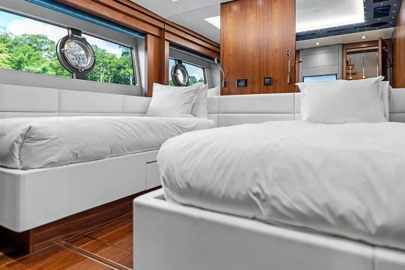 Slide: The Image of Luxurious Sunseeker 86 Yacht 2019 interior with twin beds and elegant wood paneling. - 90