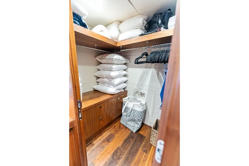 Slide: The Image of Luxurious Sunseeker 86 Yacht 2019 closet with pillows, hangers, and storage. - 97
