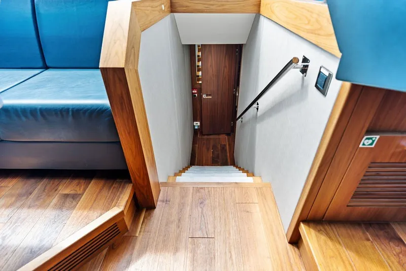 Slide: The Image of Interior of 2019 Sunseeker 86 Yacht, featuring wooden stairs and modern design elements. - 122
