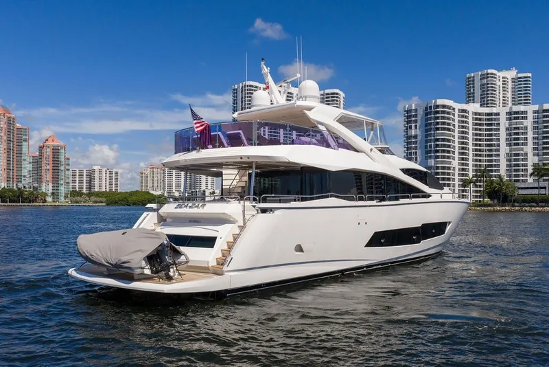 Slide: The Image of 2019 Sunseeker 86 Yacht cruising near modern city skyline on a sunny day. - 3
