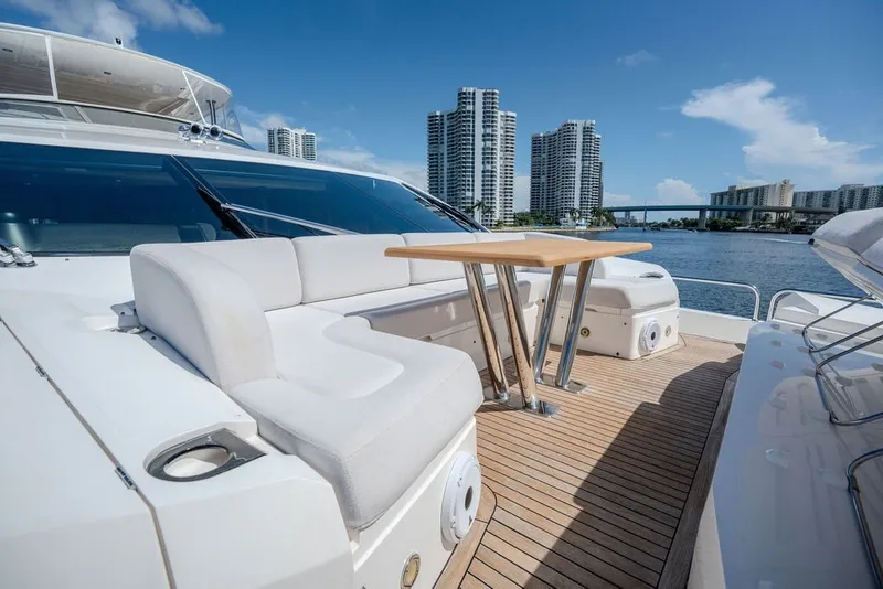 Slide: The Image of Luxurious 2019 Sunseeker 86 Yacht deck with seating, table, and city skyline view. - 32