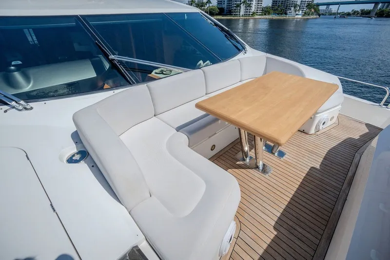 Slide: The Image of Luxurious seating area on 2019 Sunseeker 86 Yacht with wooden table and waterfront view. - 33