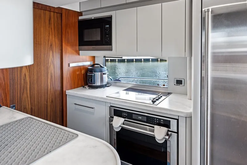 Slide: The Image of Modern kitchen interior on 2019 Sunseeker 86 Yacht with sleek appliances and waterfront view. - 124