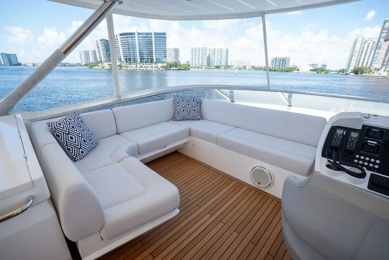 Slide: The Image of Luxurious 2019 Sunseeker 86 Yacht deck with plush seating and scenic waterfront view. - 50