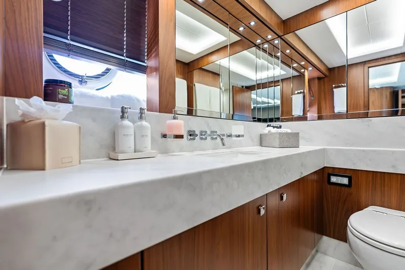 Slide: The Image of Luxurious bathroom on a 2019 Sunseeker 86 Yacht with marble countertop and wooden cabinetry. - 79