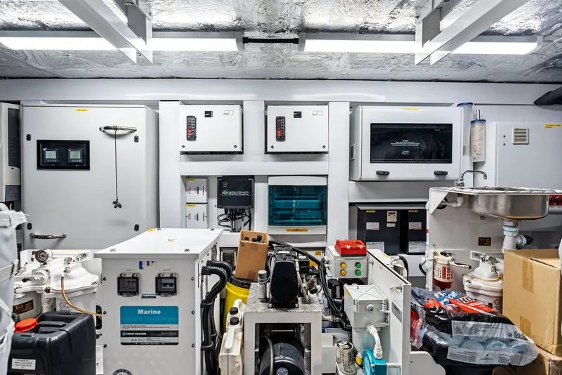 Slide: The Image of Engine room of a 2019 Sunseeker 86 Yacht, showcasing advanced marine equipment and controls. - 138