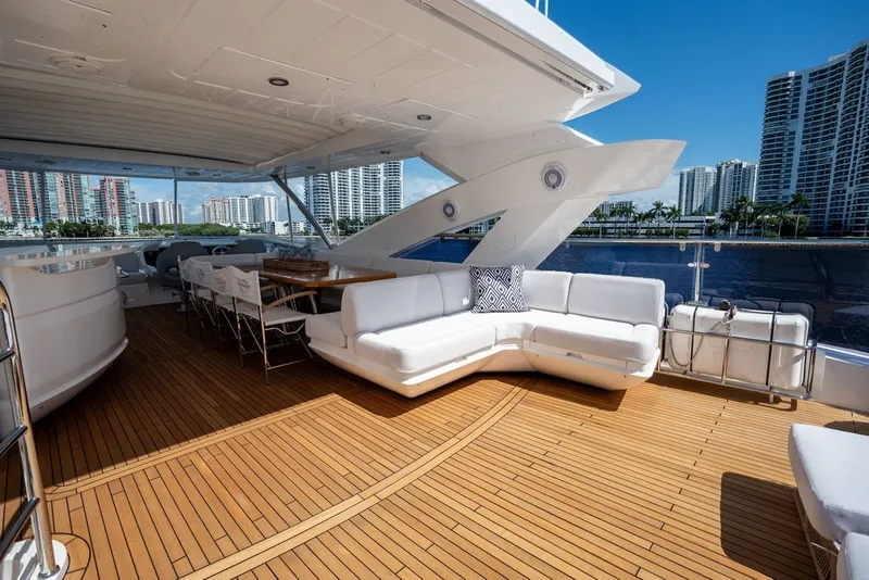 Slide: The Image of Luxurious 2019 Sunseeker 86 Yacht deck with elegant seating and scenic waterfront views. - 46