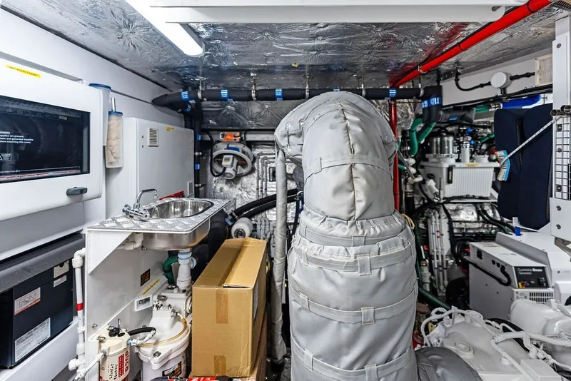 Slide: The Image of Engine room of a 2019 Sunseeker 86 Yacht, featuring complex machinery and equipment. - 139