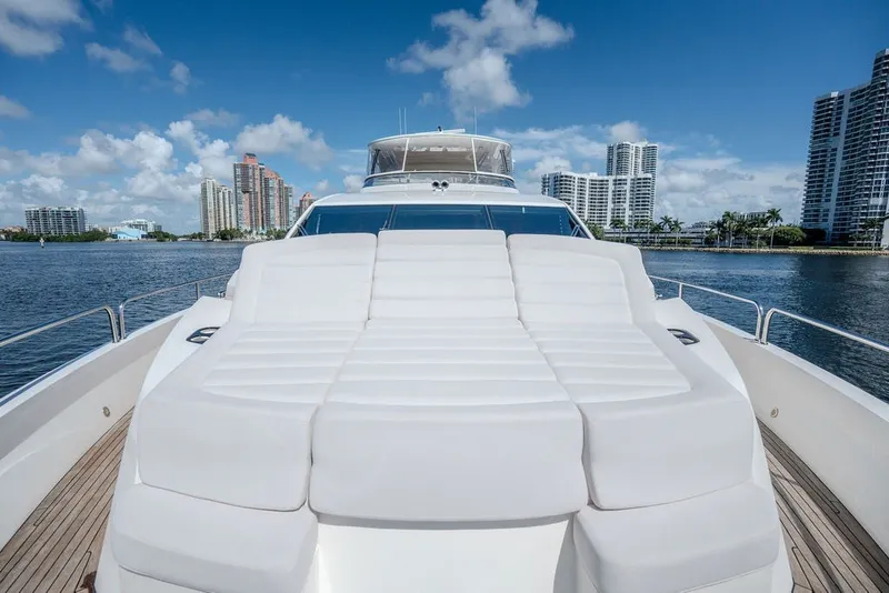 Slide: The Image of Luxurious 2019 Sunseeker 86 Yacht with spacious sunbathing deck, city skyline backdrop. - 26