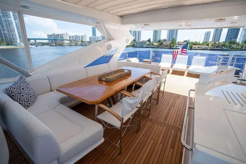 Slide: The Image of Luxurious 2019 Sunseeker 86 Yacht deck with elegant seating and scenic waterfront view. - 43