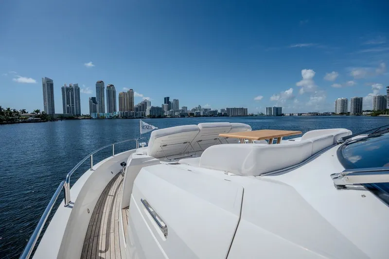 Slide: The Image of Luxurious 2019 Sunseeker 86 Yacht cruising near city skyline under clear blue sky. - 35