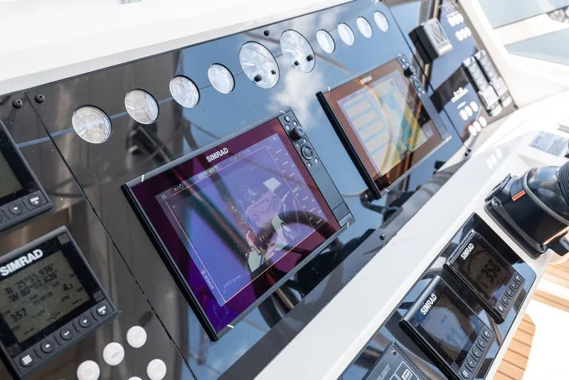 Slide: The Image of Control panel of a 2019 Sunseeker 86 Yacht with Simrad navigation displays. - 53
