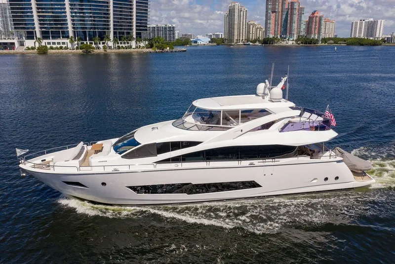 Slide: The Image of Luxurious 2019 Sunseeker 86 Yacht cruising on a scenic waterfront with modern buildings. - 17