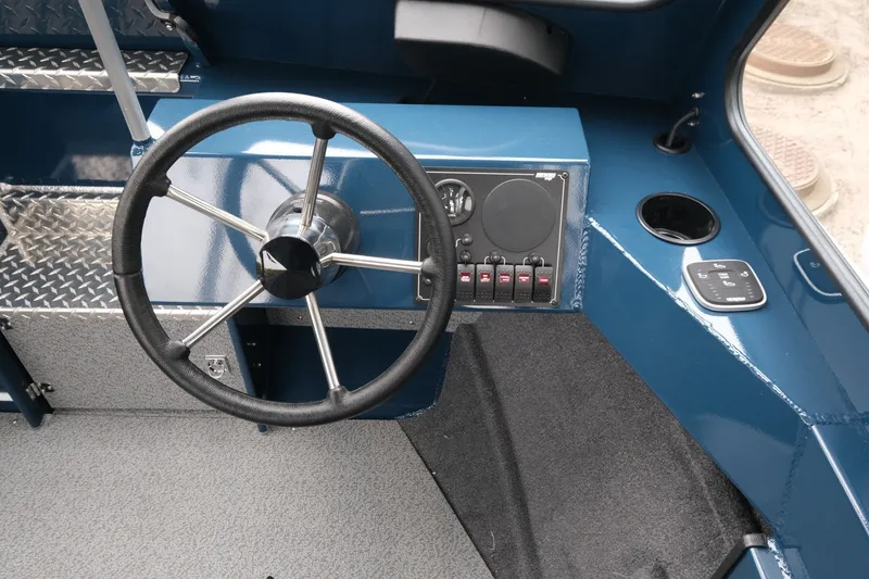 Slide: The Image of 2023 Hewescraft 200 ProV ET boat dashboard with steering wheel and control panel. - 12