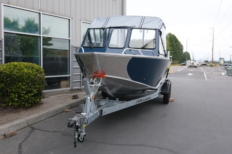 Slide: The Image of 2023 Hewescraft 200 ProV ET boat on trailer, parked outside a building. - 3