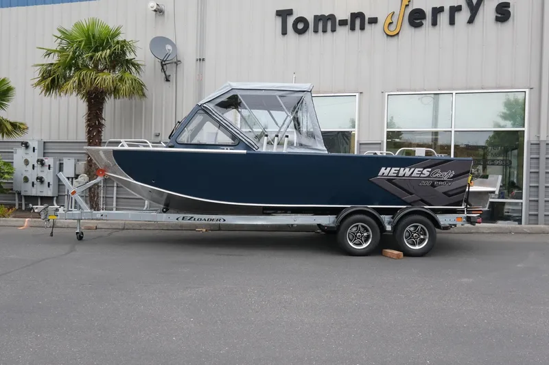 Slide: The Image of 2023 Hewescraft 200 ProV ET boat on trailer outside Tom-n-Jerry's store. - 2