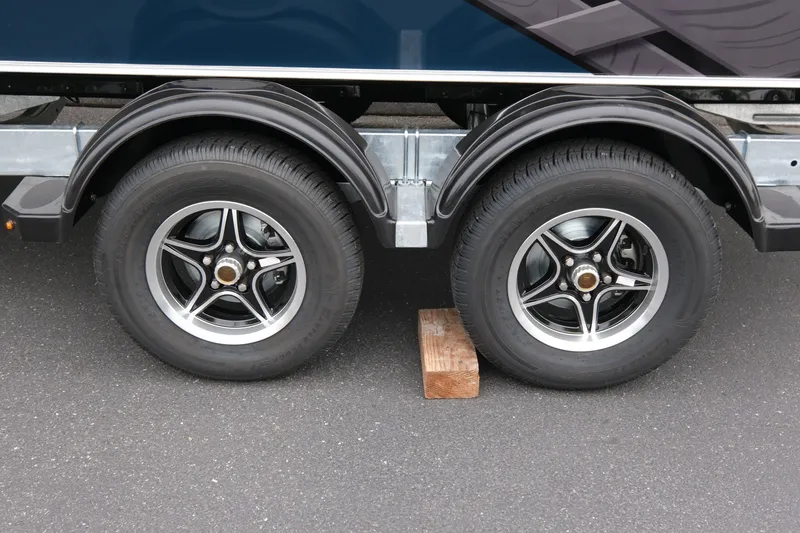 Slide: The Image of 2023 Hewescraft 200 ProV ET trailer wheels on asphalt with wooden block. - 17