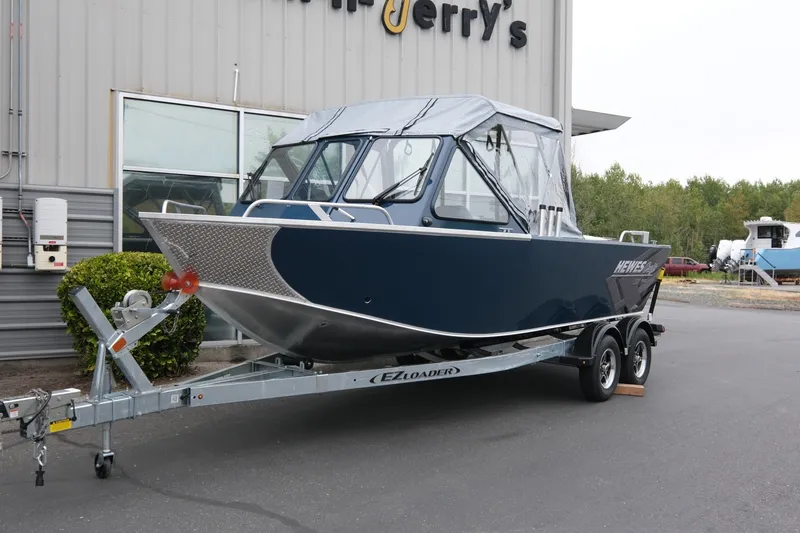 The Image of 2023 Hewescraft 200 ProV ET boat on trailer, parked outside a building. - 1