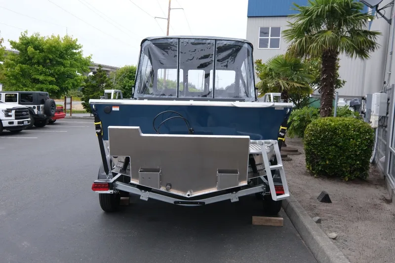 Slide: The Image of 2023 Hewescraft 200 ProV ET boat parked outdoors, rear view with trailer. - 5