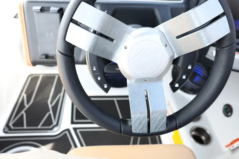 Slide: The Image of The image shows the steering wheel of a 2027 Tigé Z3 boat with modern controls. - 48