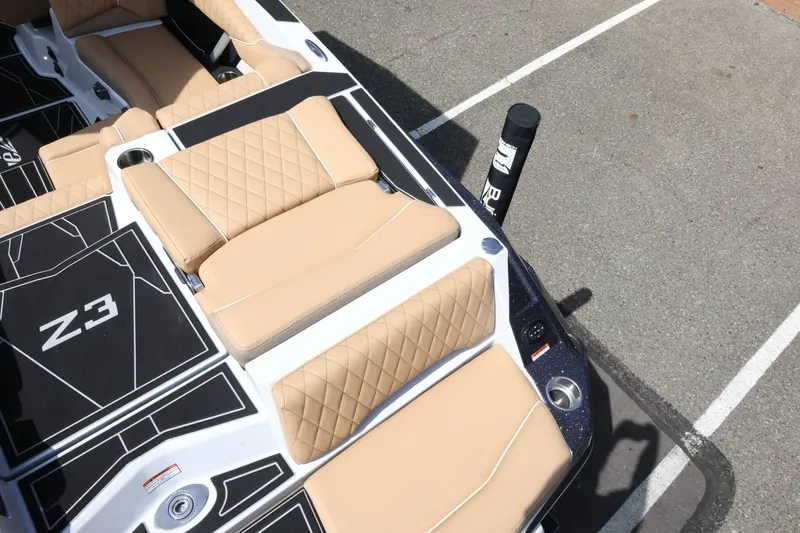 Slide: The Image of The image shows the deck of a Tigé Z3 boat with beige upholstery and black accents. - 17