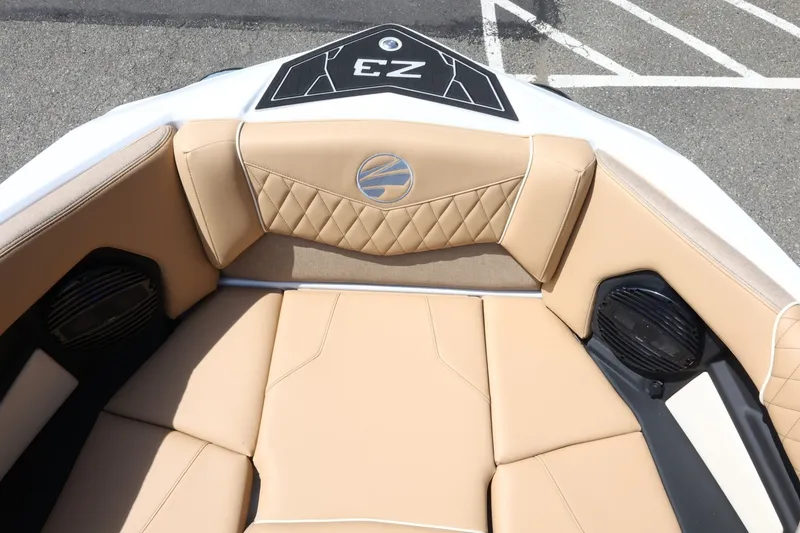 Slide: The Image of The image shows the bow of a Tigé Z3 boat with beige upholstery and speakers. - 27