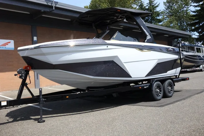Slide: The Image of A modern 2027 Tigé Z3 on a trailer, parked in front of a building. - 3