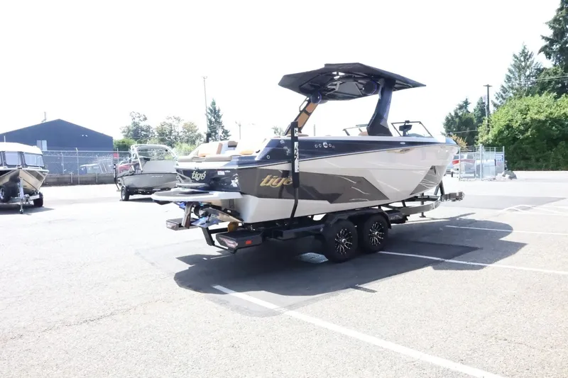 Slide: The Image of A modern 2027 Tigé Z3 boat on a trailer in a parking lot. - 10