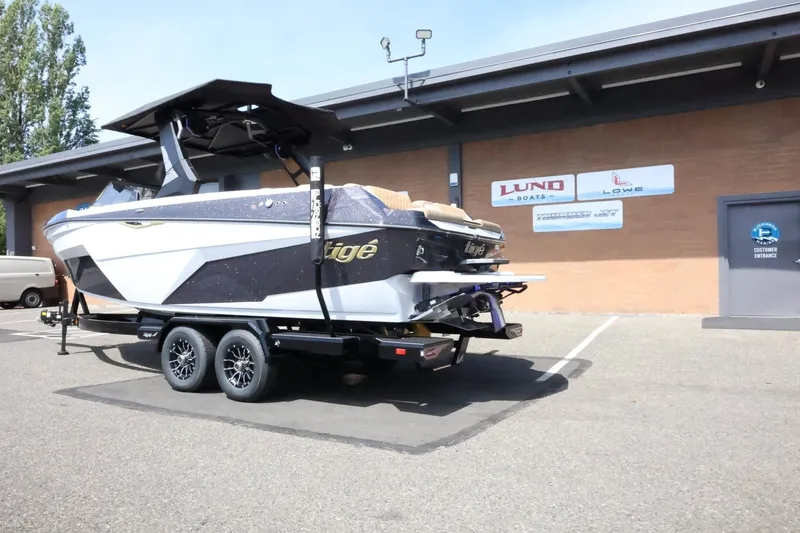 Slide: The Image of A 2027 Tigé Z3 boat on a trailer parked in front of a building. - 14