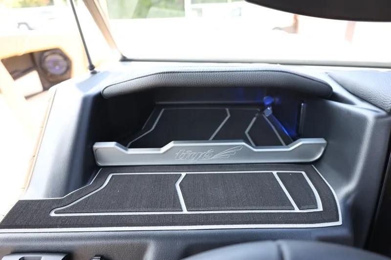 Slide: The Image of The dashboard of a 2027 Tigé Z3 featuring modern design elements and an illuminated compartment. - 37