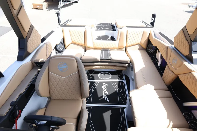 Slide: The Image of The image shows the interior of a 2027 Tigé Z3 boat with luxurious, upholstered seating. - 33