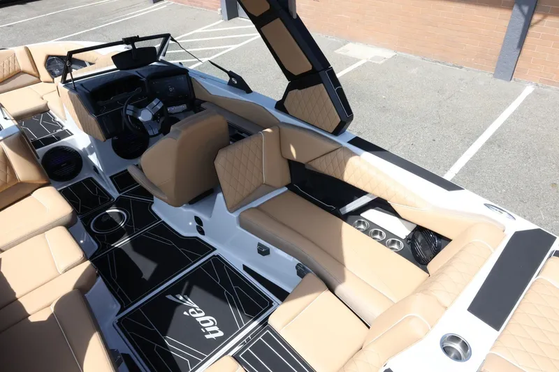 Slide: The Image of The image shows the interior of a 2027 Tigé Z3 boat with beige upholstery and modern controls. - 20