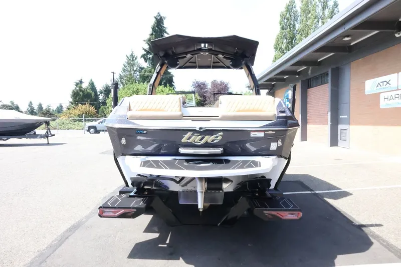 Slide: The Image of The image shows the rear of a 2027 Tigé Z3 boat parked in a lot. - 12