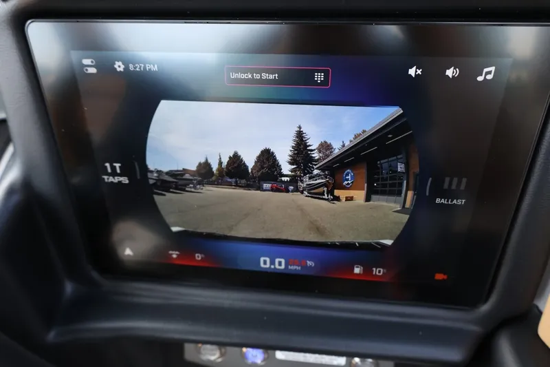 Slide: The Image of The display shows a rearview camera view with a boat on a trailer in front of a building. - 44