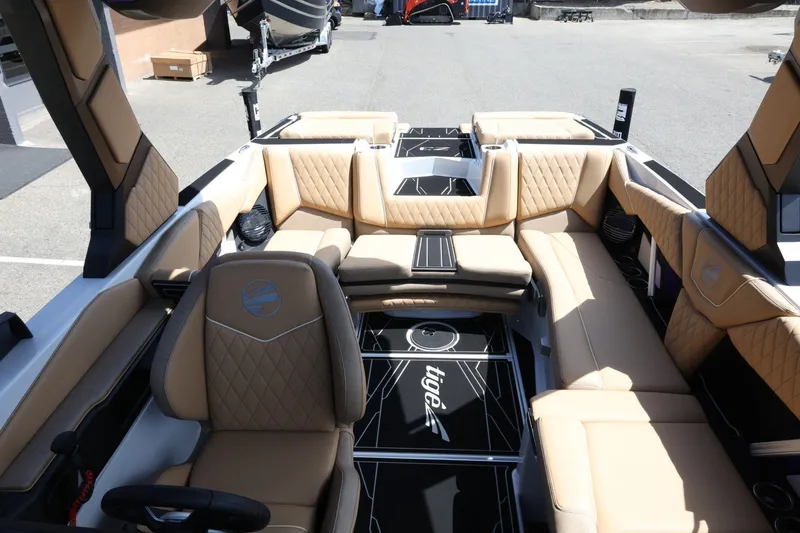 Slide: The Image of The image shows the interior of a 2027 Tigé Z3 boat with beige leather seating. - 34