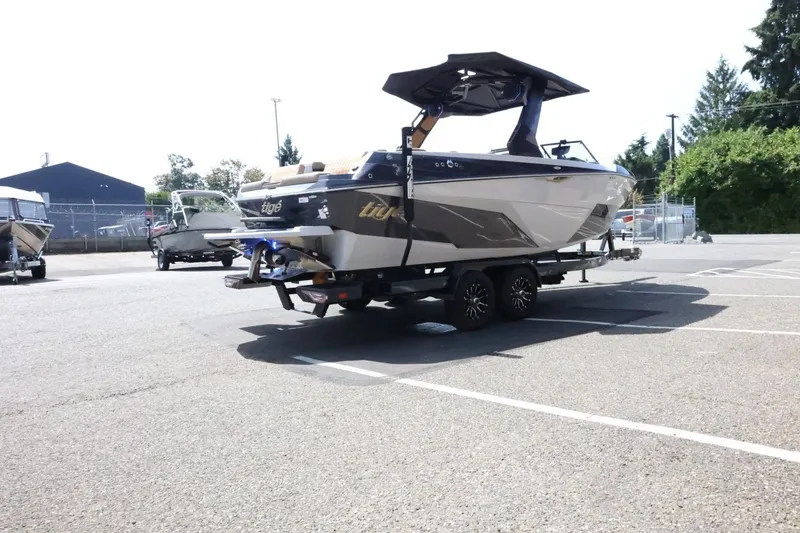 Slide: The Image of A 2027 Tigé Z3 boat on a trailer in a parking lot. - 11
