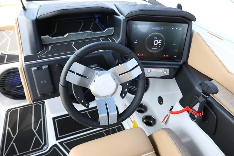 Slide: The Image of The image shows the cockpit of a 2027 Tigé Z3 boat with a modern steering wheel and digital display. - 36