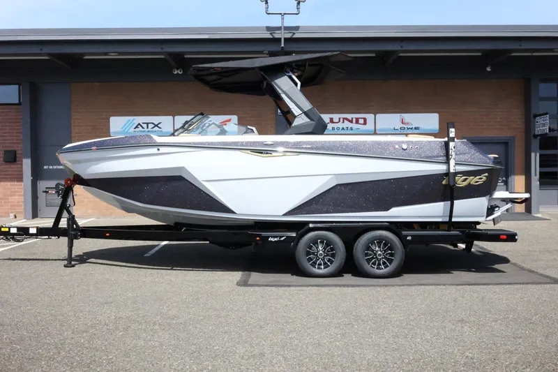 Slide: The Image of A modern 2027 Tigé Z3 on a trailer, parked in front of a building. - 2