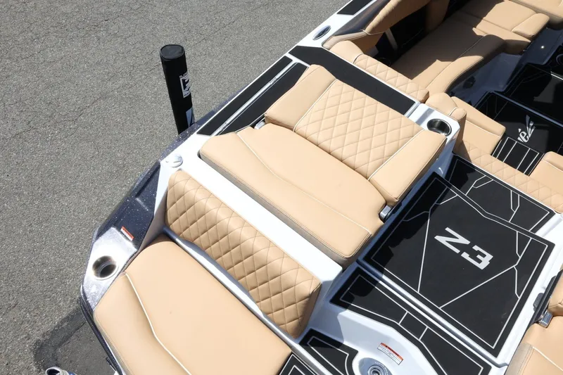 Slide: The Image of The image shows the luxurious beige upholstered seats of a 2027 Tigé Z3 boat. - 18