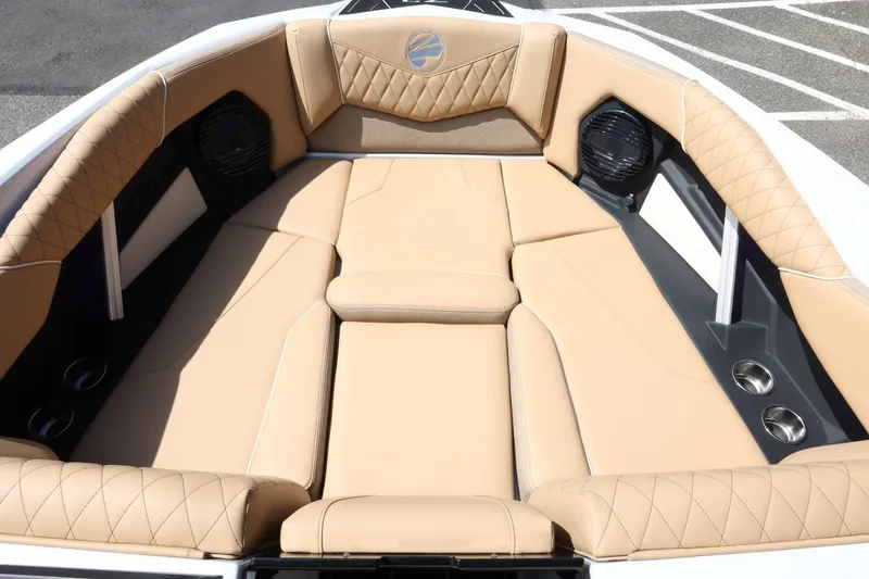 Slide: The Image of The image shows the bow area of a Tigé Z3 boat with beige upholstery and speakers. - 32