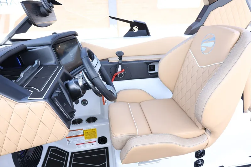 Slide: The Image of The image shows a modern boat's driver's seat with beige leather and a sleek dashboard. - 35