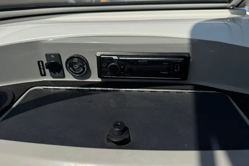 Slide: The Image of Dashboard of a 2012 Bayliner 195 Bowrider featuring a Kenwood stereo system. - 21