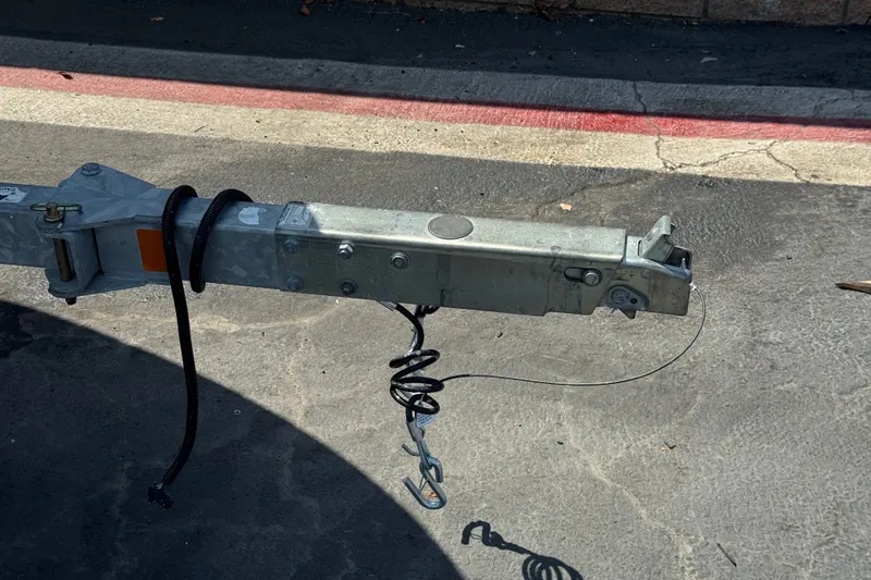 Slide: The Image of Trailer hitch of a 2012 Bayliner 195 Bowrider on pavement. - 27